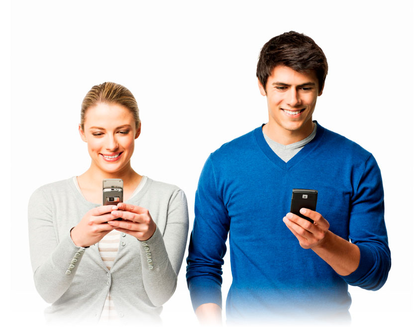 A young adult couple focused on their mobile devices