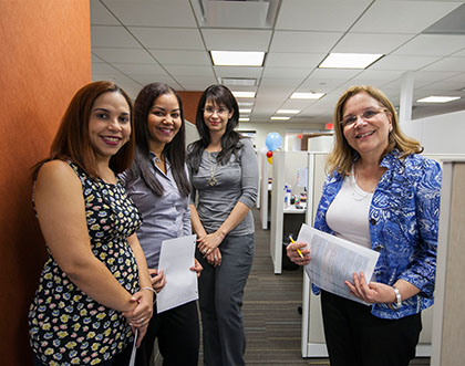 Four employees of the Nuestra Gente group of Popular