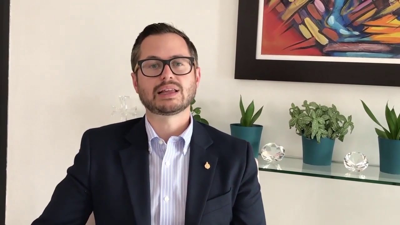 Man in suit and glasses talking about retirement plan