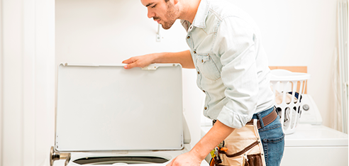 Man repairing a washing machine